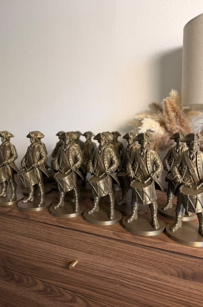 The row of bronze drummers seen from the side