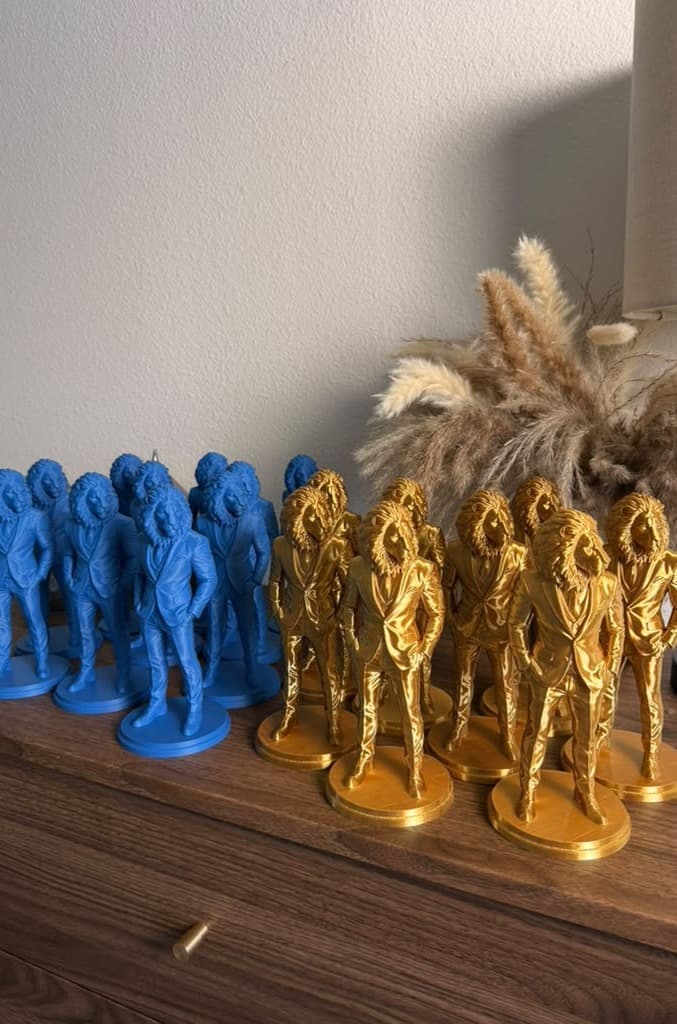 Rows of blue and gold Lion Gentleman figures on a sideboard
