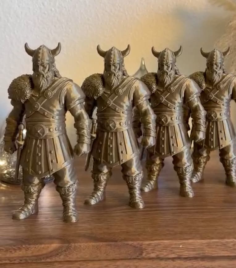 Four bronze Viking figures with horned helmets, seen up close