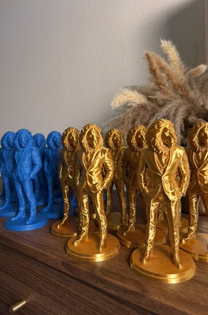 Blue and shiny gold lion-gentleman figures printed for a corporate awards ceremony